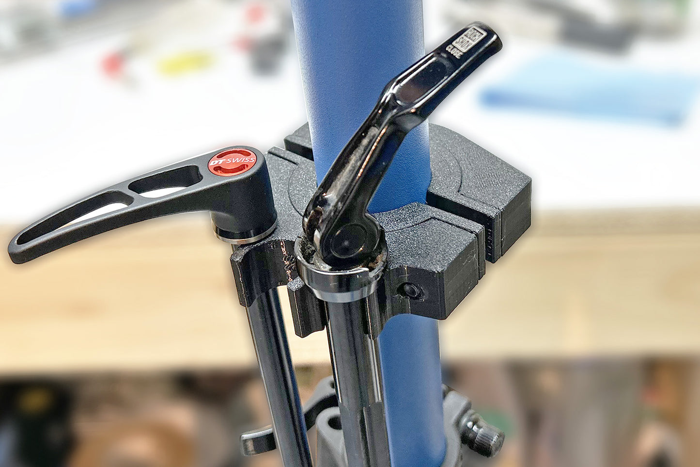 Momentum Cycle's 3D printed Axle Holder being used by a Home Mechanic on a repair bike stand.